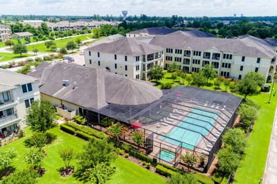 Aerial view of a senior living facility with a pool area