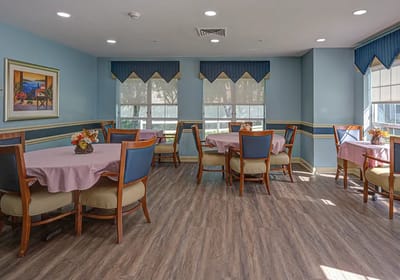 Bright dining room with tables set for meals