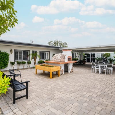 Outdoor patio area with seating and a pizza oven
