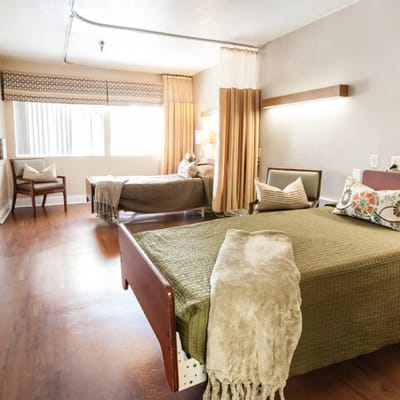 Brightly lit resident room with two beds and decor