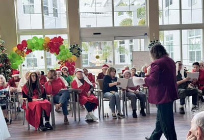 Residents and staff celebrating an event in the community area