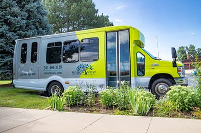 Facility transport van parked in a green space