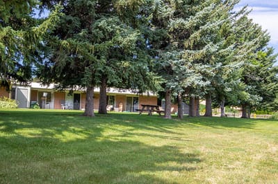 Outdoor view of assisted living facility with trees