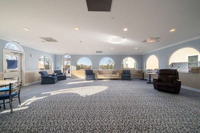 Bright common area with large arched windows and seating