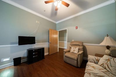 Cozy resident room with furniture and TV