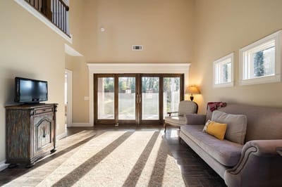 Bright common area with a sofa and large windows