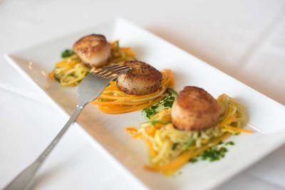 Plate of scallops with garnishes