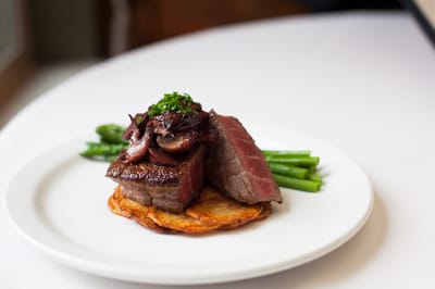 A beautifully plated meal with steak and vegetables
