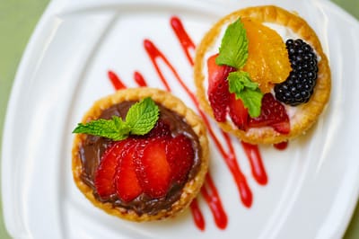 Delicious fruit tarts on a white plate