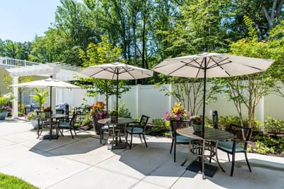 Outdoor seating area with tables and umbrellas
