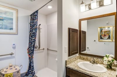 Well-lit bathroom with a modern design and floral accents
