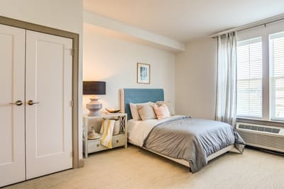 Brightly lit private resident bedroom with decorative accents