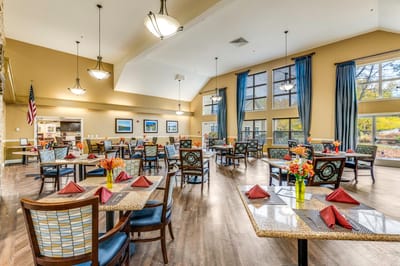 Bright dining room with tables set for a meal