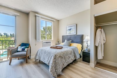 Bright and welcoming private resident room with a pool view