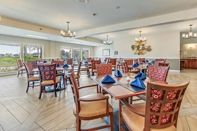 Bright dining room set for a meal with blue napkins