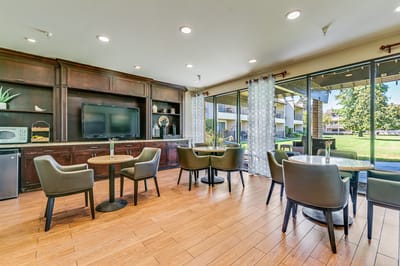 Bright common area with seating and outdoor view