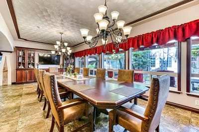 Elegant dining area with a long table and chandeliers