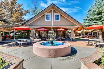 Exterior view of the assisted living facility with a fountain