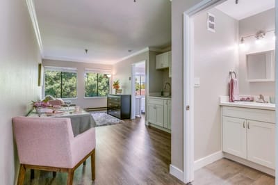 Well-lit interior of a resident room with a kitchenette