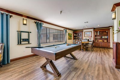 A well-lit common area with a pool table