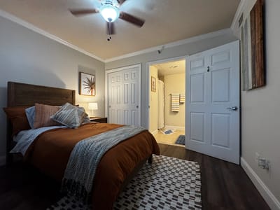 Cozy resident room with a bed and bathroom entrance