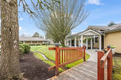 Exterior view of assisted living facility with greenery