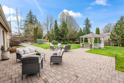 Outdoor seating area with gazebo and landscaped garden
