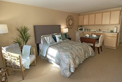Cozy resident room with a kitchenette and seating area