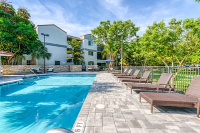 Outdoor swimming pool surrounded by lounge chairs