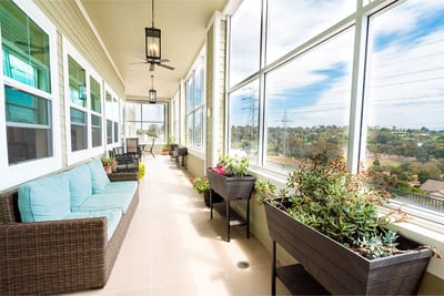 Outdoor balcony area with seating and planters