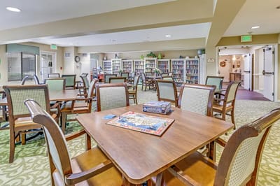 Interior view of a common area with tables and bookshelves
