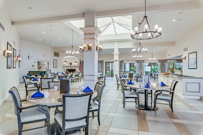 Bright dining room with tables and chairs set for dining