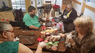 Residents decorating cookies during a festive activity.