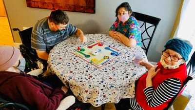 Residents playing a game together at a table