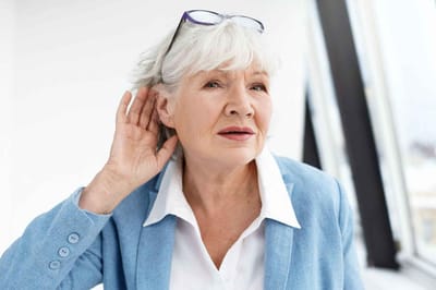 Visiting Angels Living Assistance Services, home care in Sterling Heights, MI — Senior woman listening attentively in a bright room