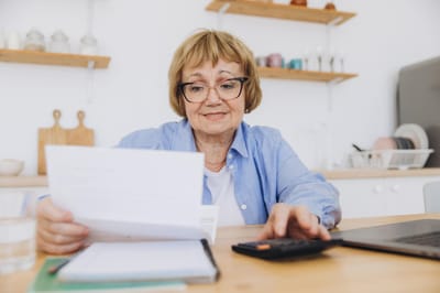 Senior woman reviewing documents at a table