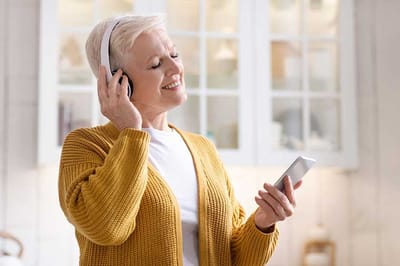 Senior woman enjoying music with headphones