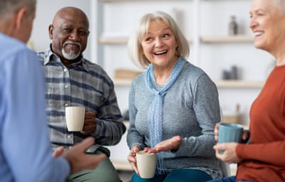 Residents engaged in conversation with mugs