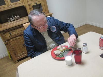 Resident enjoying a meal in the dining area