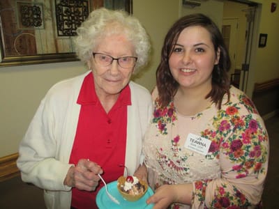Resident and staff member enjoying dessert together