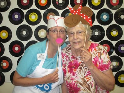 Staff and resident having fun with photo props