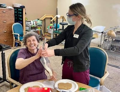 A resident enjoying an activity with staff.