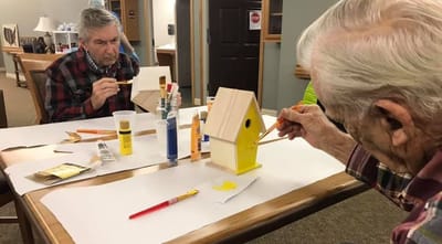Residents engaging in a crafts activity at a table