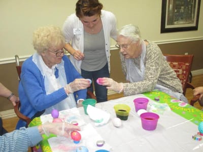 Residents decorating Easter eggs in an activity room