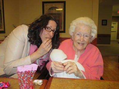 A staff member interacts with a resident in a common area