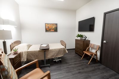 A private resident room with a bed and furniture