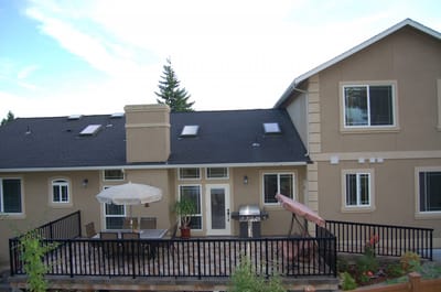 Exterior view of a senior care home with outdoor patio furniture