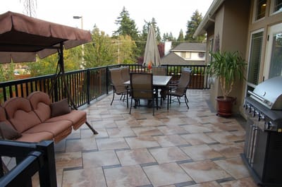 Outdoor patio with seating and grill area