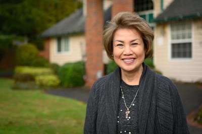 Smiling woman standing outside a facility