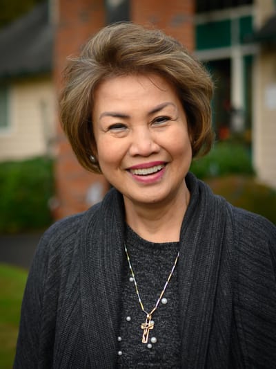 Smiling resident in a garden setting